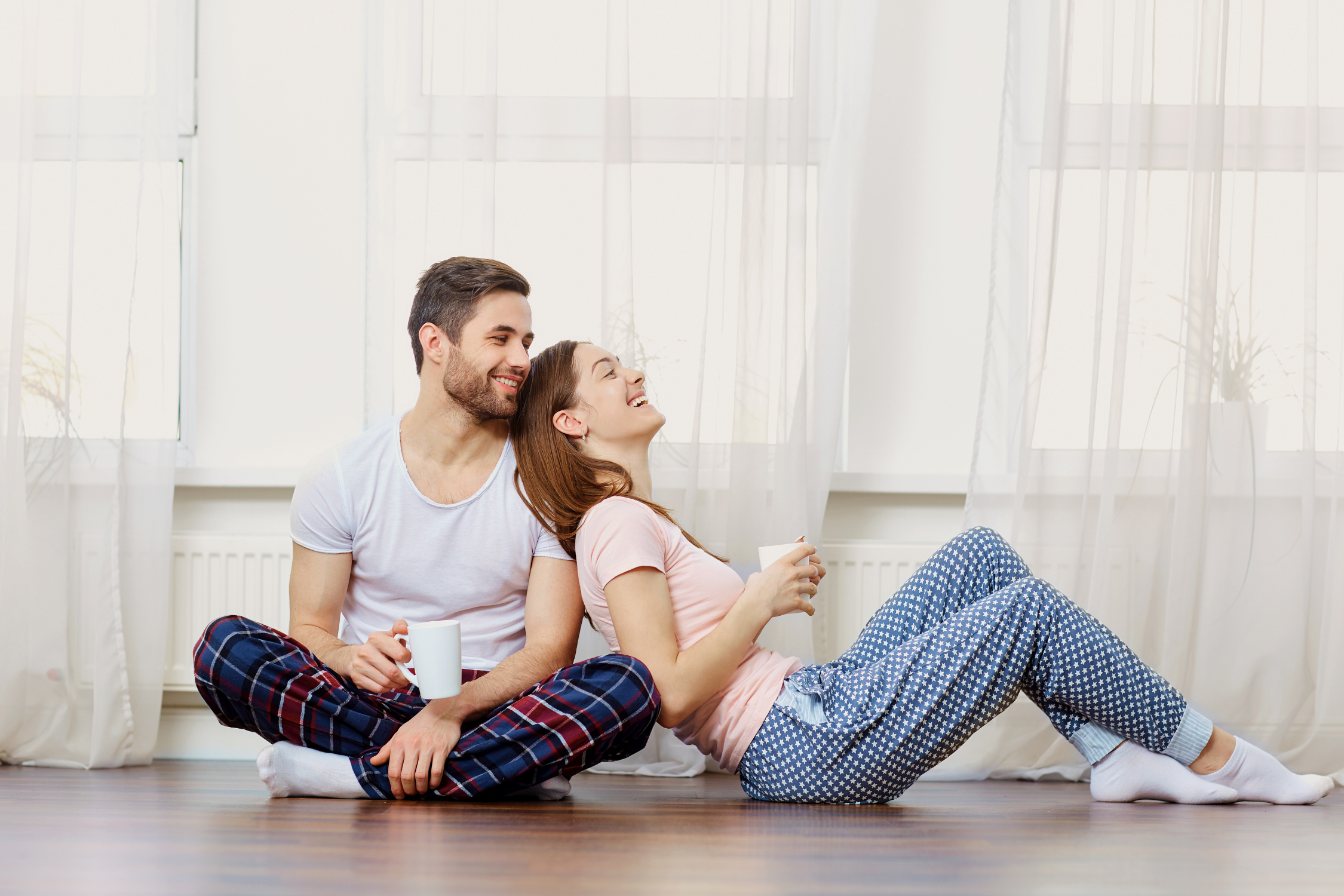 Couple enjoying coffee laughing and talking