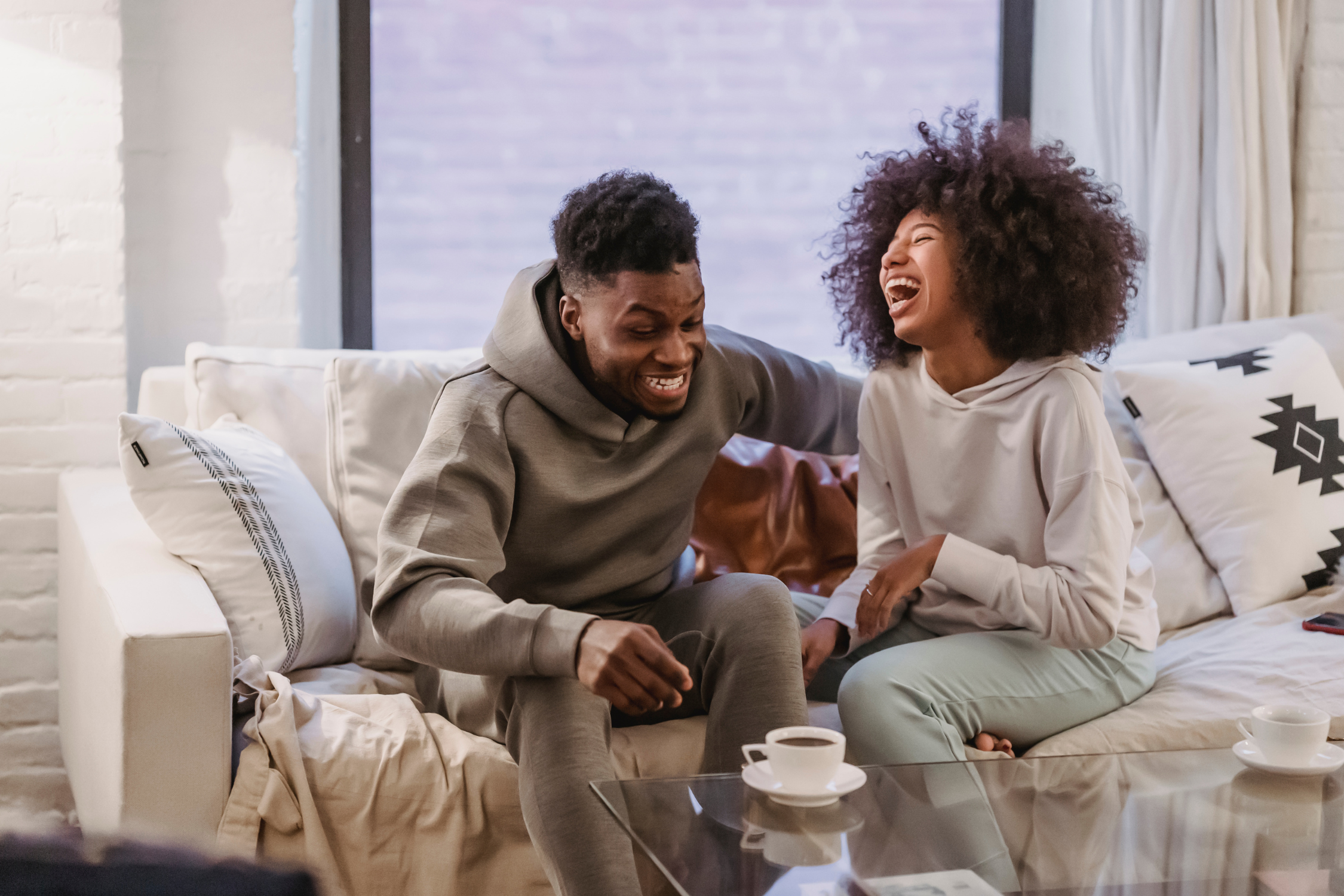 Couple laughing on sofa